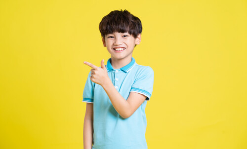 1920 portrait of an asian boy posing on a yellow background